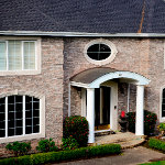 Fullview of home with domed copper entryway