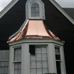 New shiny copper roofing being freshly installed