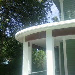 Curving seamless radius gutter wrapping around a round porch